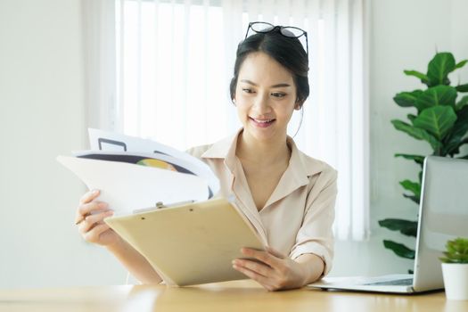 new normal, a businesswoman using computer and open document to work for a company Via the internet on your desk at home.