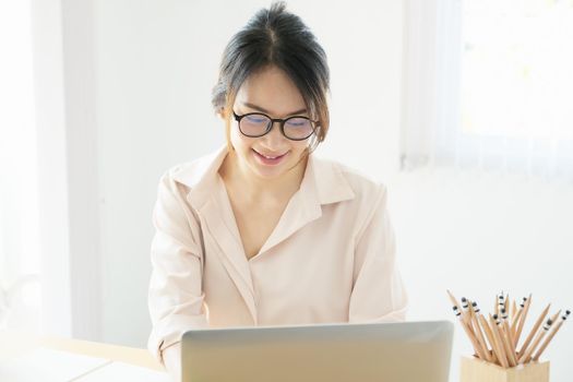 new normal, a businesswoman useing computer to work for a company Via the internet on your desk at home. vintage effect