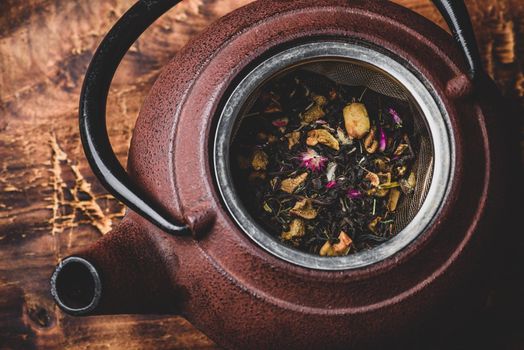 Preparing herbal tea with fruit pieces. High angle view