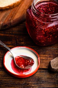 Jar of homemade raspberry jam. Toasts for breakfast.