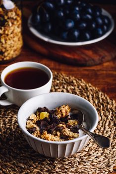 Bowl with Homemade Granola, Dried Fruits and Chocolate for Breakfast