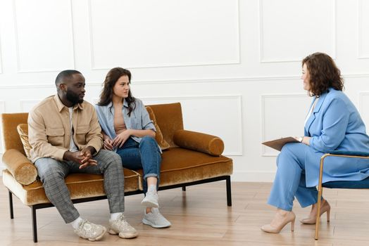 A diverse couple came to a session with a psychologist. Relationship problems, avoiding divorce.