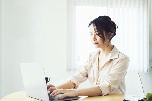 new normal, a businesswoman using computer to work for a company Via the internet on your desk at home.