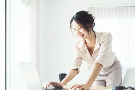 new normal, a businesswoman using computer to work for a company Via the internet on your desk at home