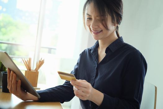 Online payment, Young Women's hands holding tablet and credit card for online shopping