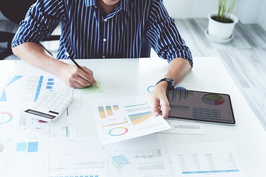 businessman hands using a calculator to check company finances and earnings and budget. calculating monthly expenses, managing budget, papers, loan documents, invoices concepts.