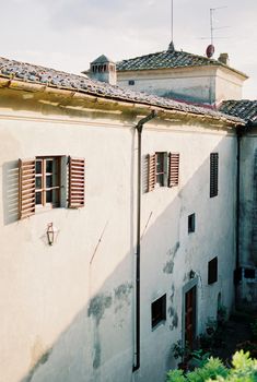 Windows with shutters on the facade of an old villa. High quality photo