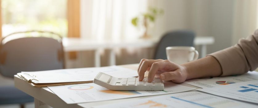 Close up a accountant working about financial with calculator at office to calculate expenses, Accounting concept