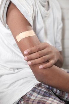 adhesive bandage on young man's arm .