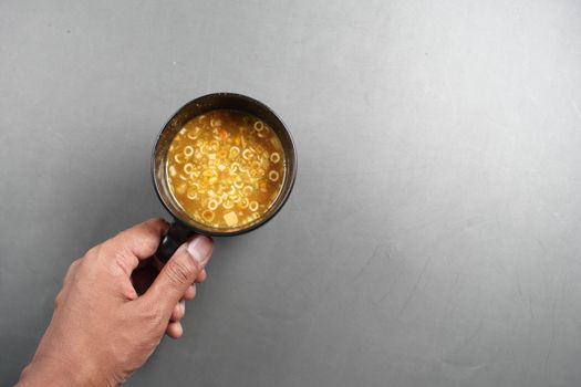 instant cup soup in a mug on table .