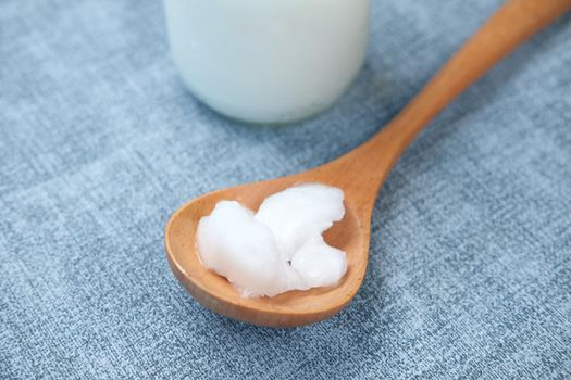 spoon with coconut oil on table ,