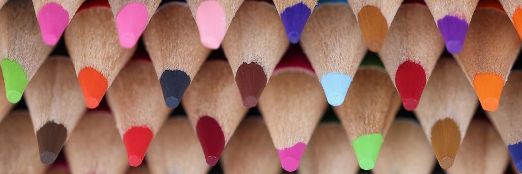 Close-up of sharpened colourful pencil set for painting forming stack placed on each other. Pigmented crayons for drawing on paper. Creativity, art concept