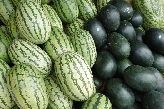 many water melon display for sale at local store ,