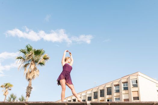 young caucasian ballet dancer dancing free in the city, dance and freedom concept, copy space for text