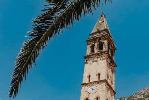 Historic city of Perast at Bay of Kotor in summer, Montenegro. Scenic panorama view of the historic town of Perast at famous Bay of Kotor with blooming flowers on a beautiful sunny day with blue sky and clouds in summer, Montenegro, southern Europe