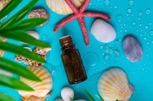 Essential oil on sea background. Selective focus. Spa.