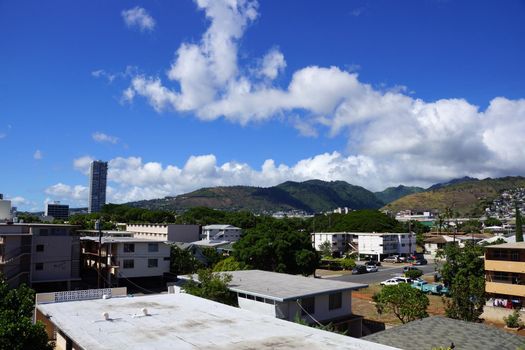 Kapahulu town in Honolulu with homes, condos, and mountains of Tantalus and St. Louis Heights on a clear day on Oahu, Hawaii