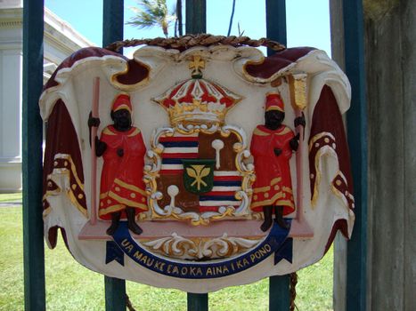 Historic Royal Seal at Iolani Palace one of 16 Bronze Coat of Arms of the government of Hawaii with the state motto: "Ua Mau Ke Ea o Ka Aina i ka Pono" (The life of the land is perpetuated in rightrousness).