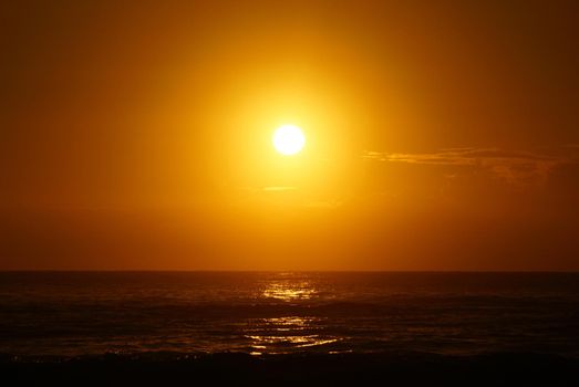 Spectacular Sunrise over the ocean with waves crashing along shore in Hana on Maui, Hawaii.    