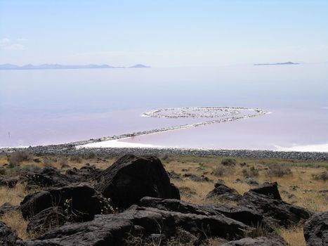 SALT LAKE, UTAH - AUGUST 25: Spiral Jetty swirls in the pink blue water on a clear day seen from the rocky shore, Robert Smithson's masterpiece earthwork, on the north side of the Great Salt Lake, about two-and-a-half hours from Salt Lake City. AUGUST 25, 2005.