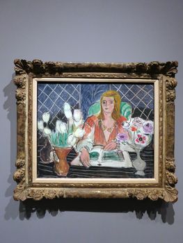 Annelies, White Tulips and Anemones - painting by Henri Matisse from 1944.

The painting depicts a woman smiling at a table with flowers aligned on it. The painting is currently in the Honolulu Museum of Art.
