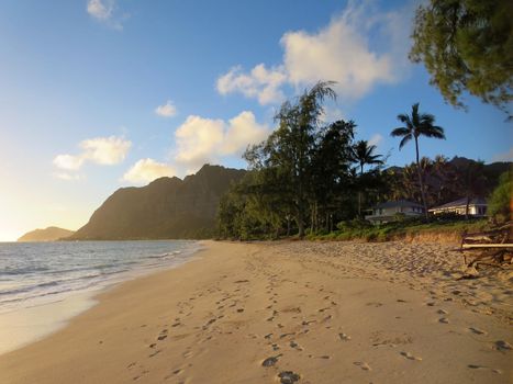 Gentle wave lap on Waimanalo Beach in the early morning light on a nice day Oahu, Hawaii.