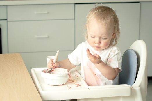 cute baby toddler learn to eat soup. High quality photo