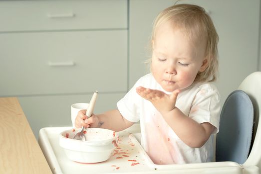 cute baby toddler learn to eat soup. High quality photo