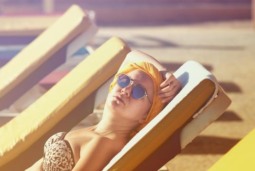 young woman sunbathing at the sea terrace . High quality photo