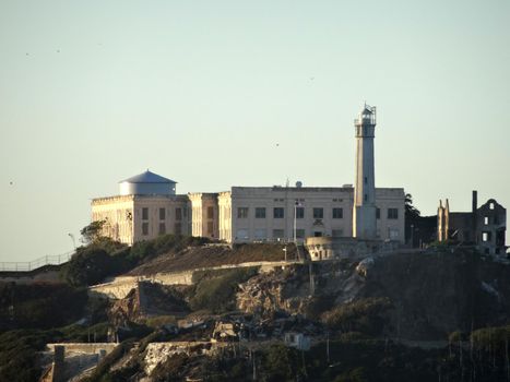 Alcatraz Island with Lighthouse and Prison and birds flying around on a nice Day, October 2015.