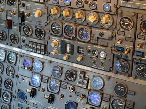 Jet aircraft cockpit Equipment with various indicators, buttons, dials, and instruments.