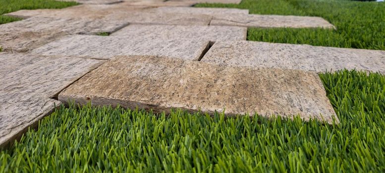 green lawn image that can be used as a natural background with cobblestones