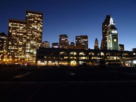 SAN FRANCISCO - OCTOBER 12:  San Francisco's waterfront landmark - the Ferry Building Clock Tower and cityscape at night with 1915 on side marking it's 100 year anniversary in California on October 12, 2015.