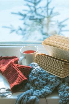 snow outside the window and open book indoor