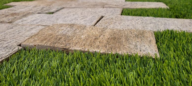 green lawn image that can be used as a natural background with cobblestones