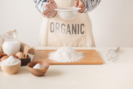 Flour sifting through a sieve for a baking