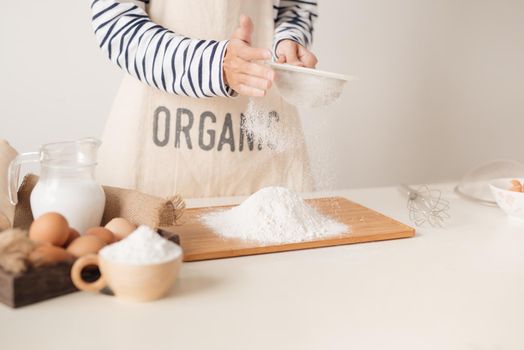 Flour sifting through a sieve for a baking