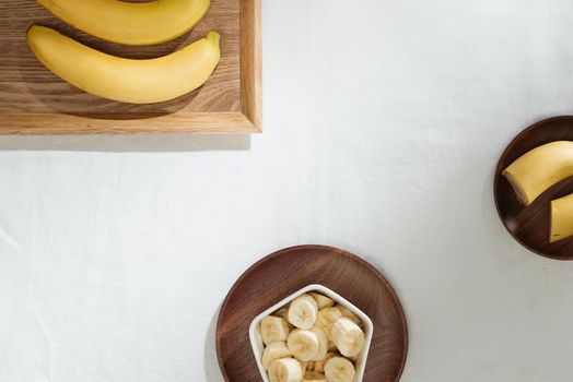 Bananas and banana pieces in a wooden plate