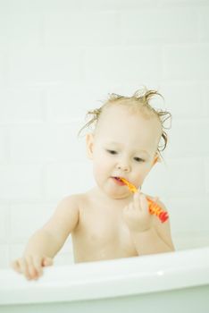 cute babygirl in bathroom baby learning to clean teeth with toothbrush