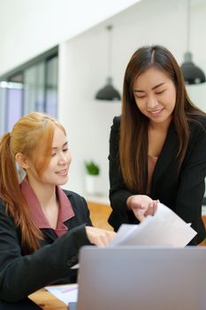 Portrait of an Asian businesswoman consulting, start up a marketing plan to meet the needs of customers in office room