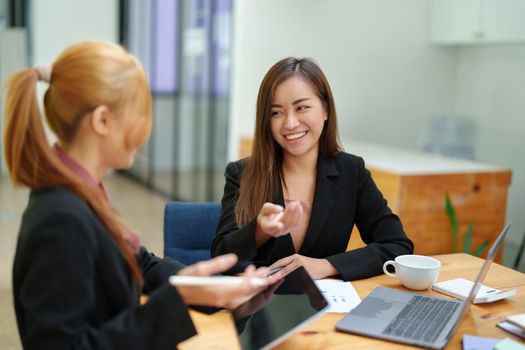 Portrait of an Asian businesswoman consulting, start up a marketing plan to meet the needs of customers in office room