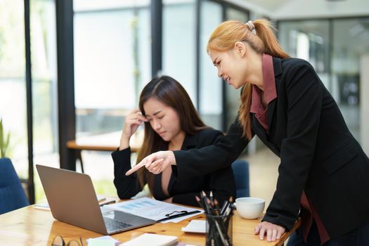 The portrait of an Asian female worker was warned by her supervisor as the profitability sales did not meet the planned targets.