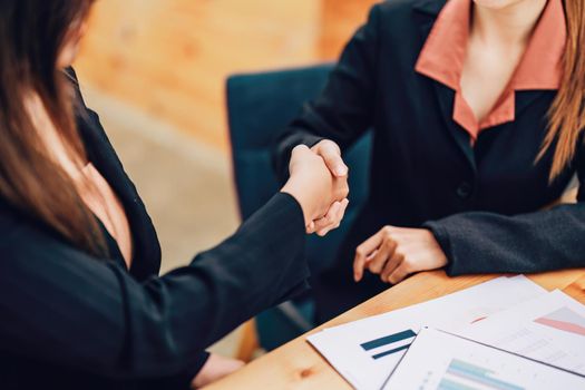 business merger, Asian businesswoman shake hands at the conference room with showcase their collaboration to strengthen their marketing efforts