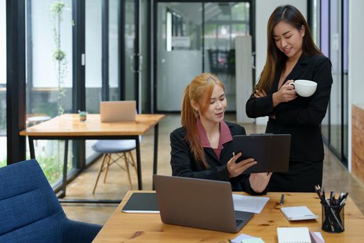 Portrait of an Asian businesswoman consulting, start up a marketing plan to meet the needs of customers in office room