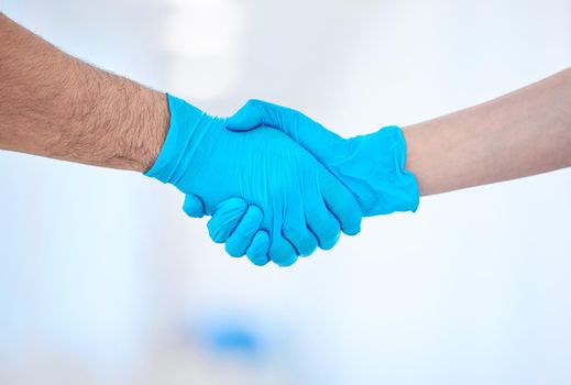 a two dental coworkers shaking hands.