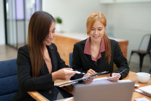 Portrait of an Asian businesswoman consulting, start up a marketing plan to meet the needs of customers in office room