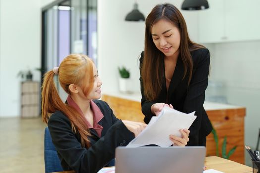 Portrait of an Asian businesswoman consulting, start up a marketing plan to meet the needs of customers in office room