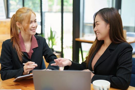 Portrait of an Asian businesswoman consulting, start up a marketing plan to meet the needs of customers in office room