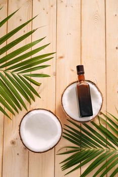 coconuts and coconut oil on wooden background.