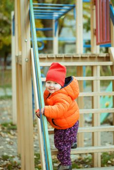 the child climbs the steps on the playground. High quality photo